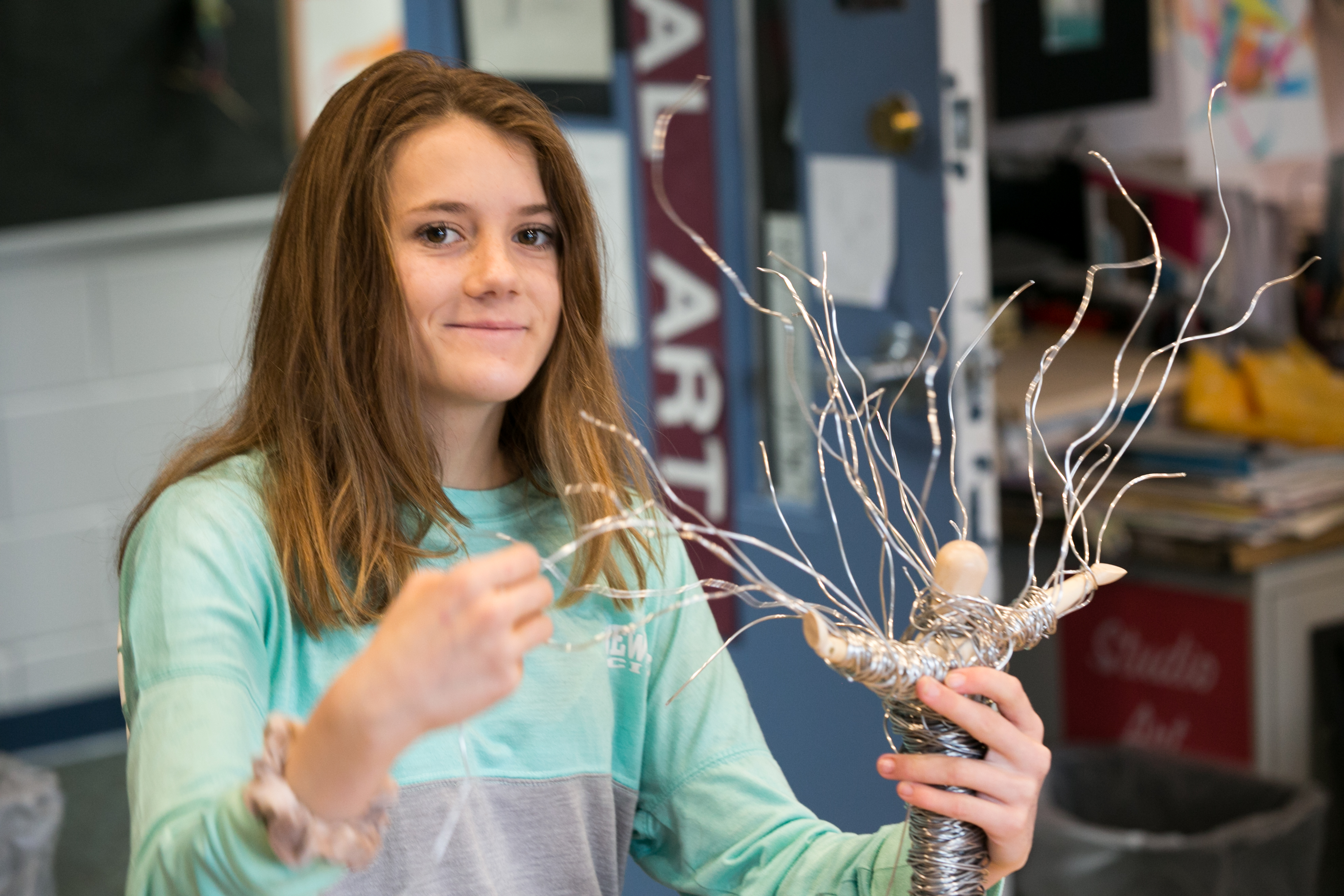 Student making wire tree in art