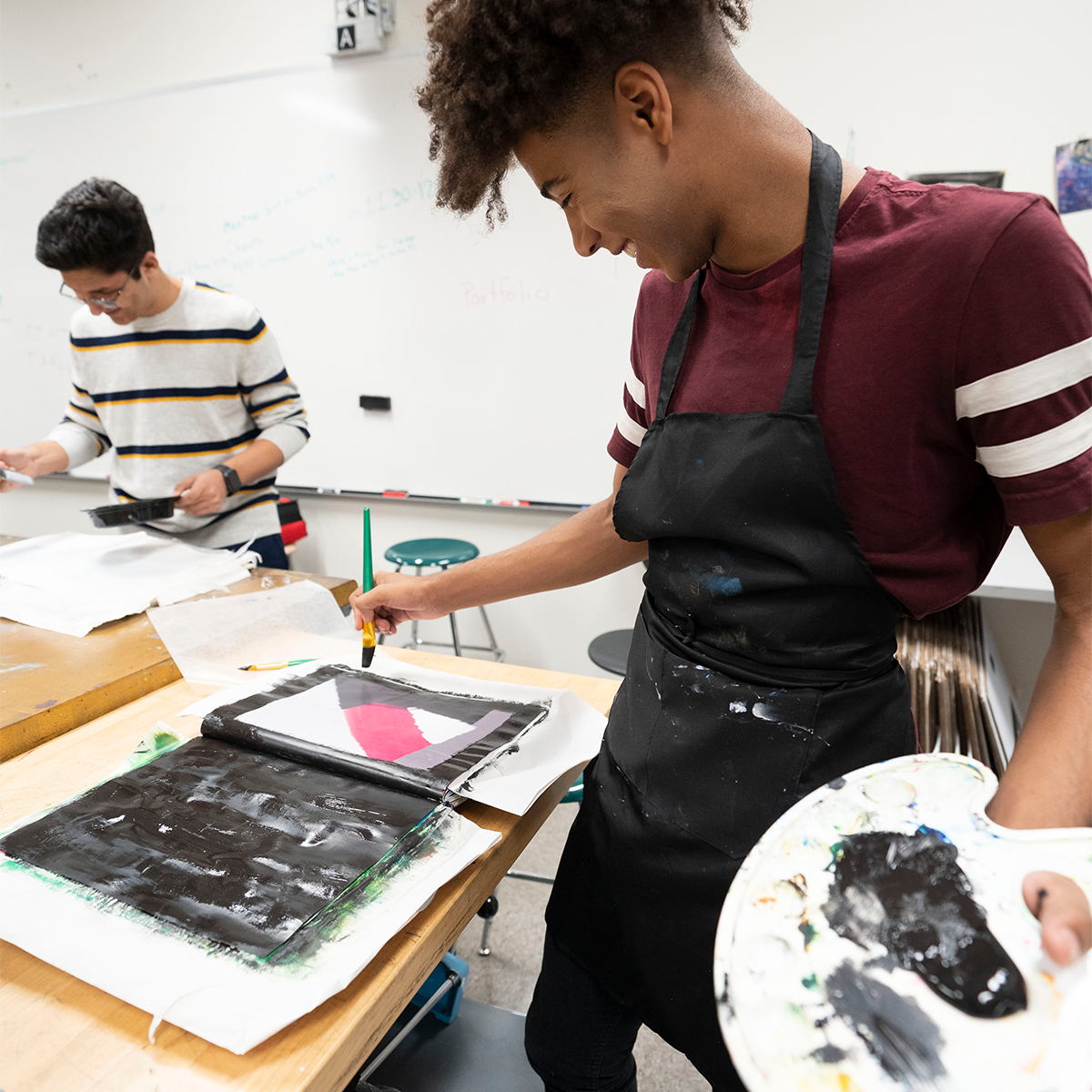 Student using canvas to paint a book