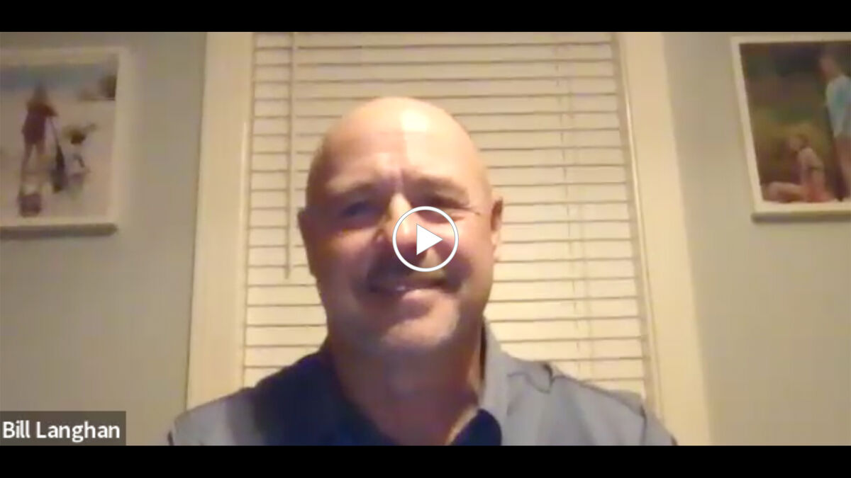 Bill Langham smiling at computer desk