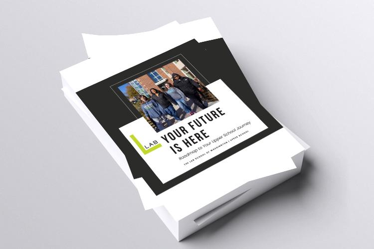 stack of brochures with the front cover on top of students standing outside the school