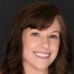 Headshot of a brunette woman smiling