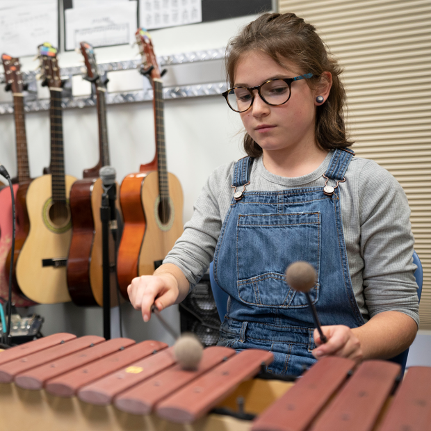 A student playing the xylophone. 