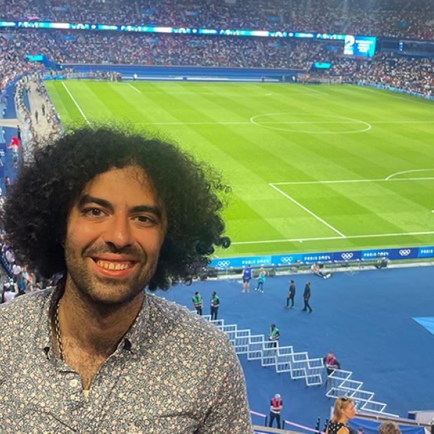 Camilo Rivera smiling inside of a soccer stadium