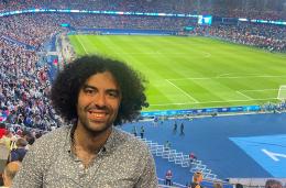 Camilo Rivera smiling inside of a soccer stadium