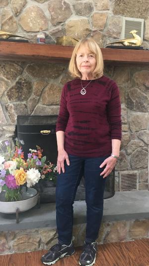 photo of head of school in front of fireplace