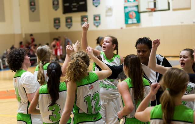 Girls varsity basketball team huddles for inspiration