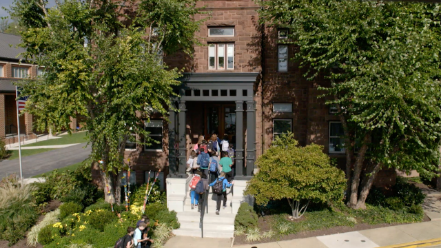 Students walk up the steps into the Castle building