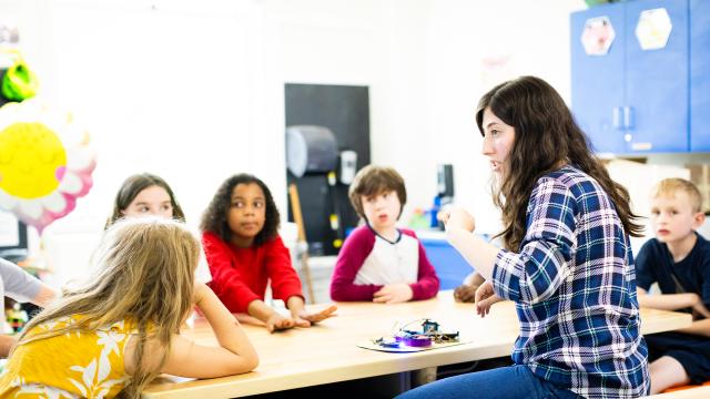 students and teacher around table