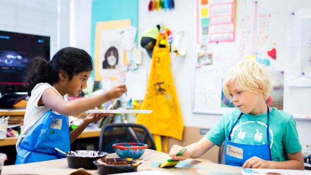two students painting