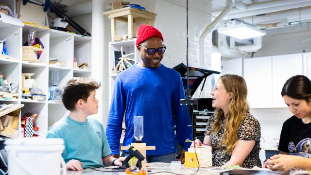 students and teacher around a table