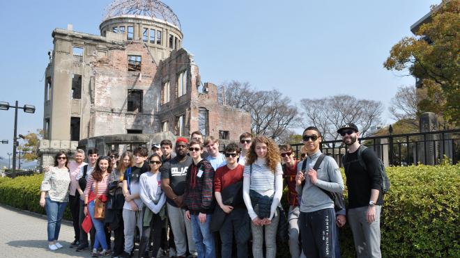 Group of high school students in front of old building