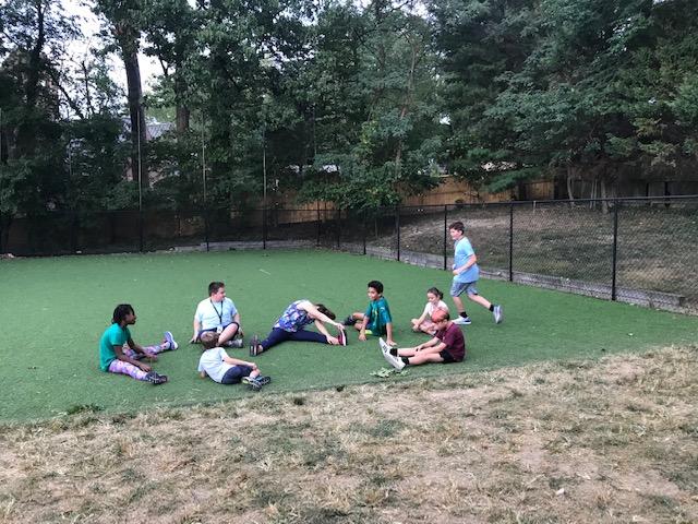 students in playground stretching