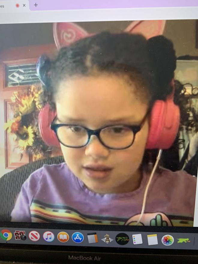 young female student with headphones on zoom classroom
