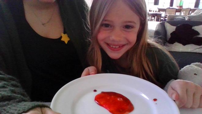 girl holding plate with rock on it