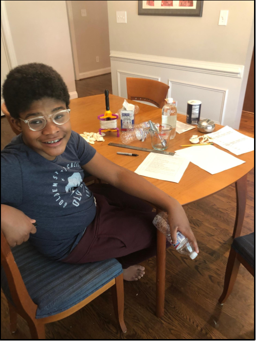 student performing science experiment at home