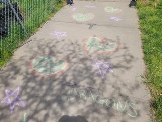 Drawing chalk messages on school driveway