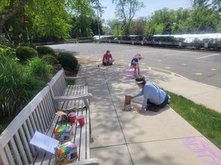 Drawing chalk messages on school driveway