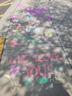 Drawing chalk messages on school driveway