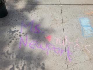 Drawing chalk messages on school driveway