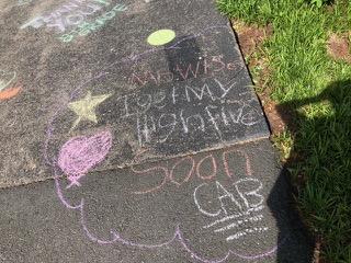 Drawing chalk messages on school driveway