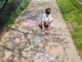 Drawing chalk messages on school driveway