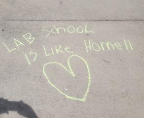 Drawing chalk messages on school driveway