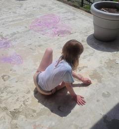 Drawing chalk messages on school driveway