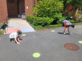 Drawing chalk messages on school driveway