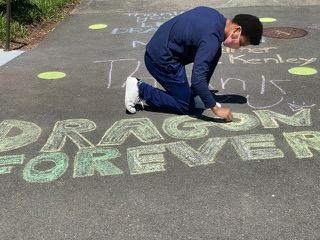 Drawing chalk messages on school driveway