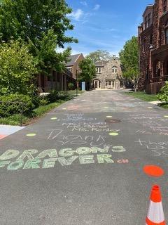 drawing chalk messages on school driveway
